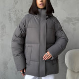 Piumino oversize da donna con cappuccio e tasche