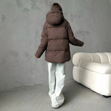 Piumino oversize da donna con cappuccio e tasche