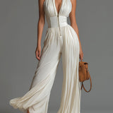 White sleeveless V-neck jumpsuit with zip closure.