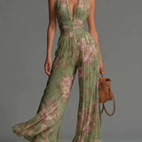 White sleeveless V-neck jumpsuit with zip closure.