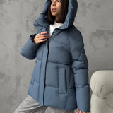 Piumino oversize da donna con cappuccio e tasche