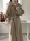 Cappotto lungo elegante da donna con cintura e revers