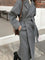 Cappotto lungo elegante da donna con cintura e revers